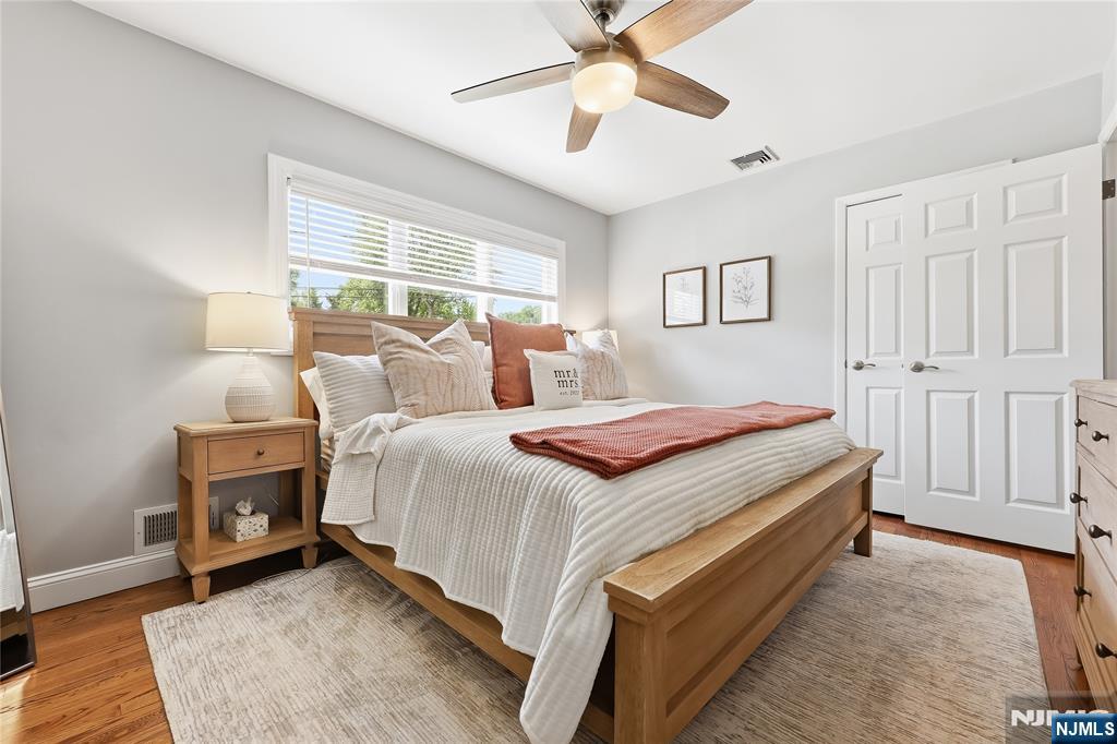 77 White Pond Road Waldwick, NJ 07463 - Photo 14 of 33 a bedroom with a bed and a chandelier