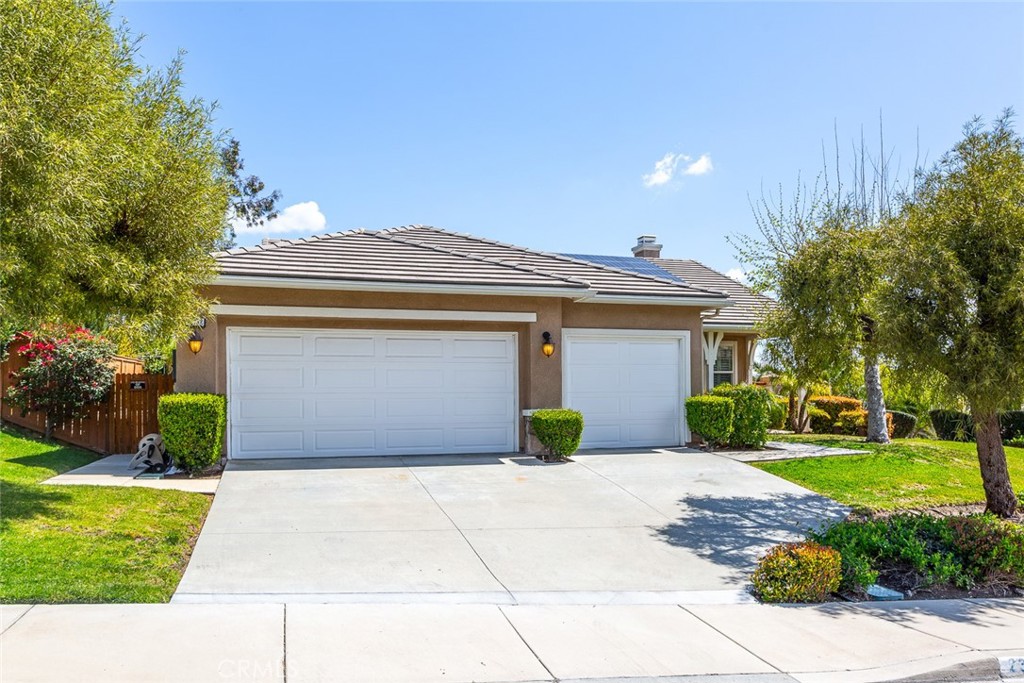 23732 Bella Vista Road Corona, CA 92883 - Photo 1 of 1 a front view of a house with a garden and plants