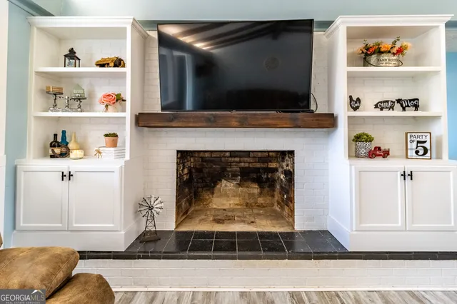 a living room with a fireplace and a flat screen tv