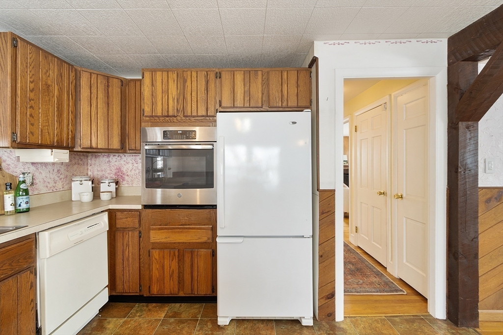 10 Pilling Road Wilmington, MA 01887 - Photo 11 of 41 a white refrigerator freezer sitting in a kitchen