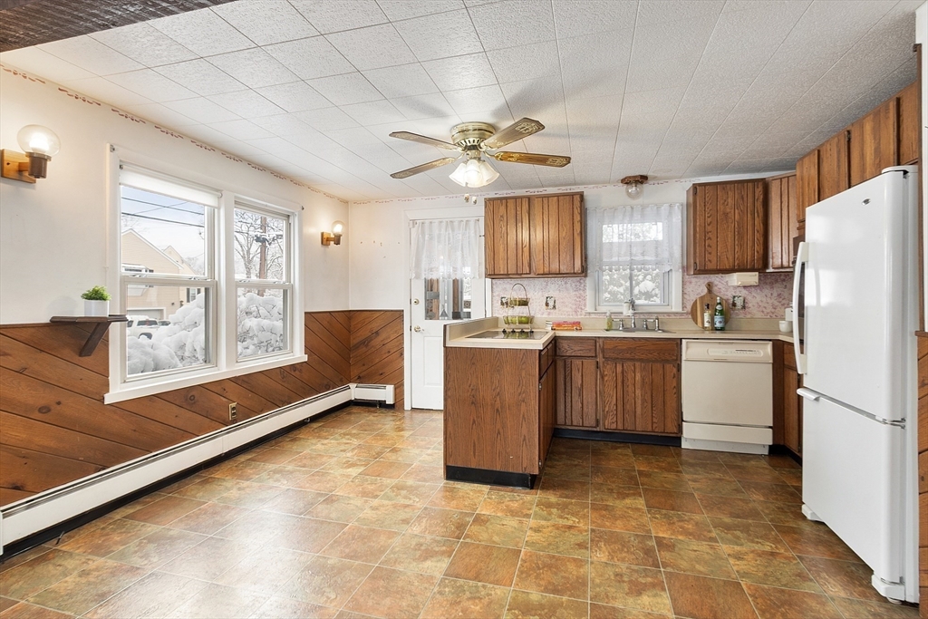 10 Pilling Road Wilmington, MA 01887 - Photo 12 of 41 a kitchen with a refrigerator a sink and cabinets