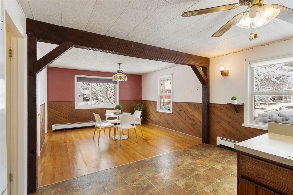 10 Pilling Road Wilmington, MA 01887 - Photo 13 of 41 a living room with furniture a large window and wooden floor