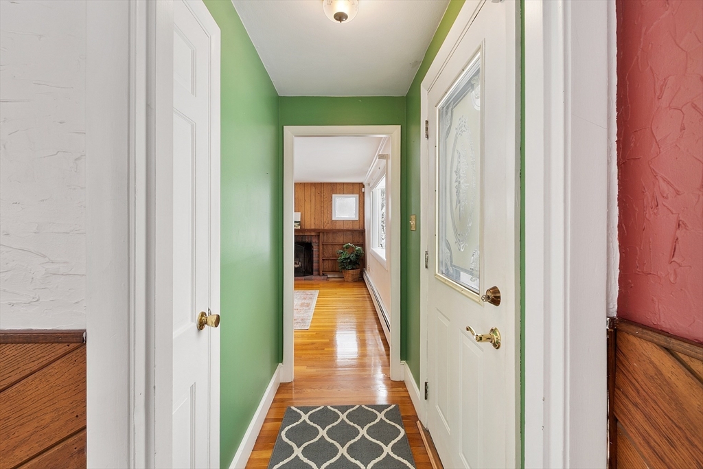 10 Pilling Road Wilmington, MA 01887 - Photo 17 of 41 a view of a hallway with a livingroom and a bathroom with sink