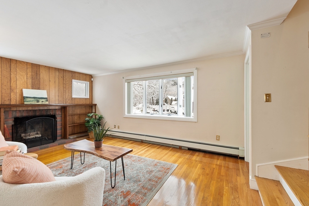 10 Pilling Road Wilmington, MA 01887 - Photo 19 of 41 a living room with furniture and a fireplace
