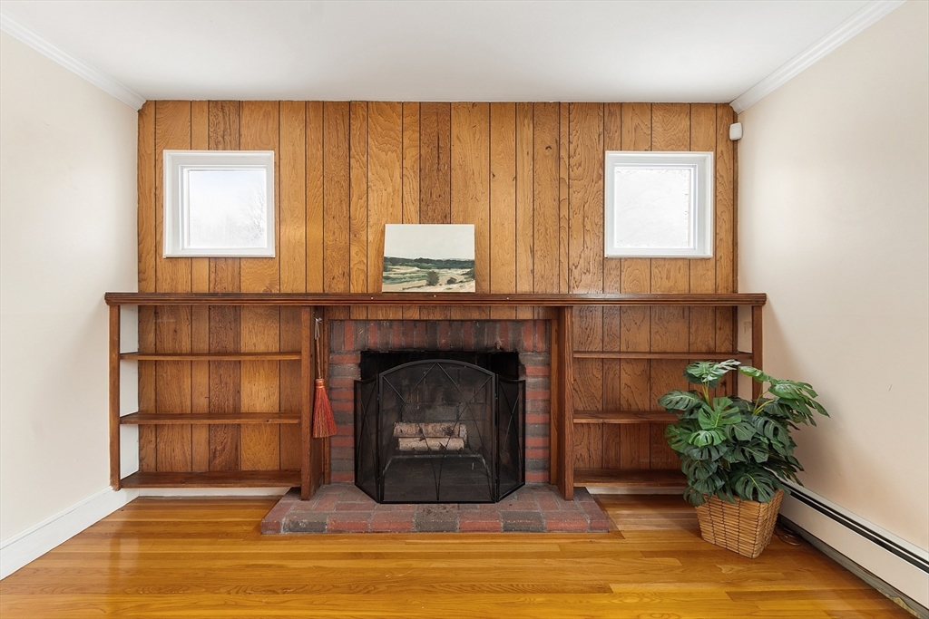 10 Pilling Road Wilmington, MA 01887 - Photo 21 of 41 a living room with a fireplace and potted plants
