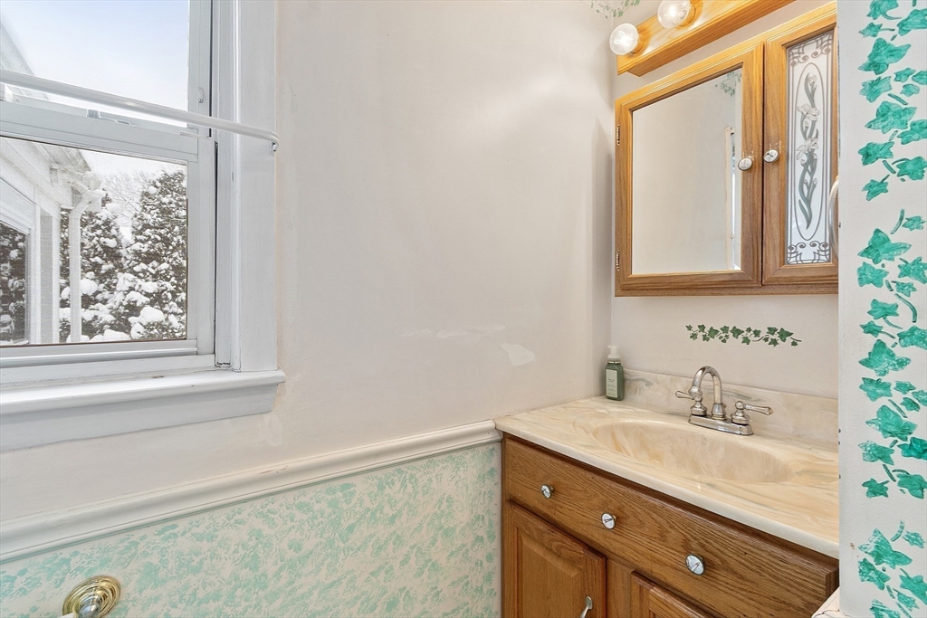 10 Pilling Road Wilmington, MA 01887 - Photo 24 of 41 a bathroom with a granite countertop sink mirror and a window
