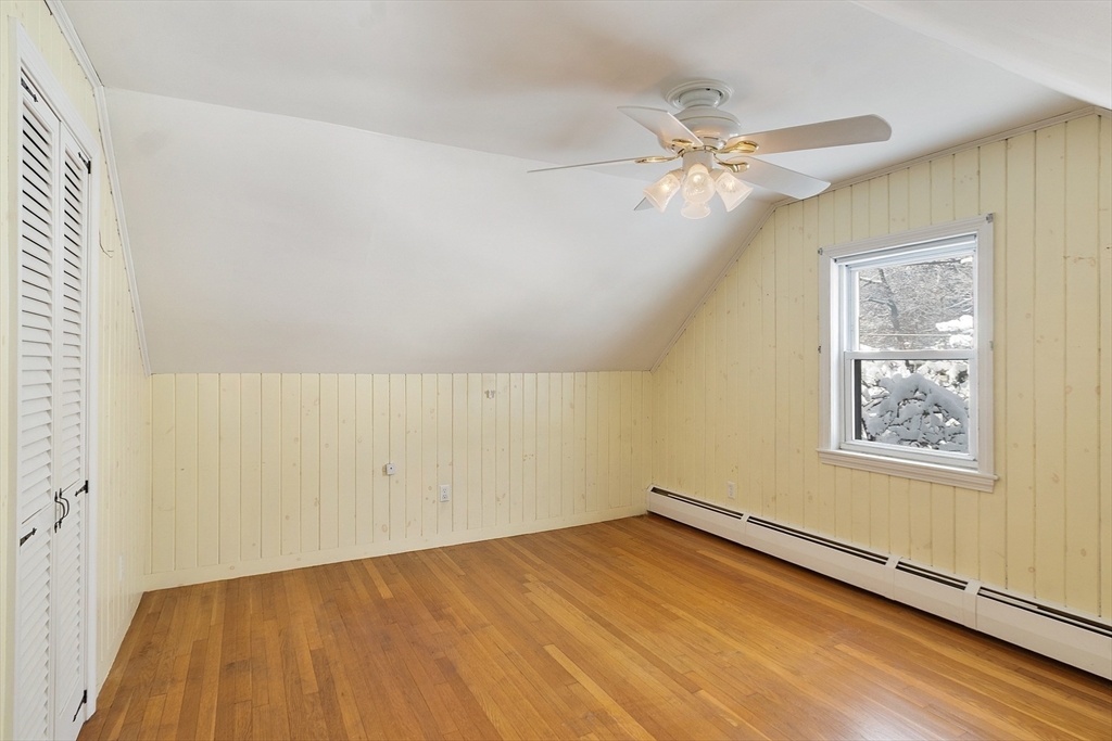 10 Pilling Road Wilmington, MA 01887 - Photo 29 of 41 an empty room with a chandelier fan and windows
