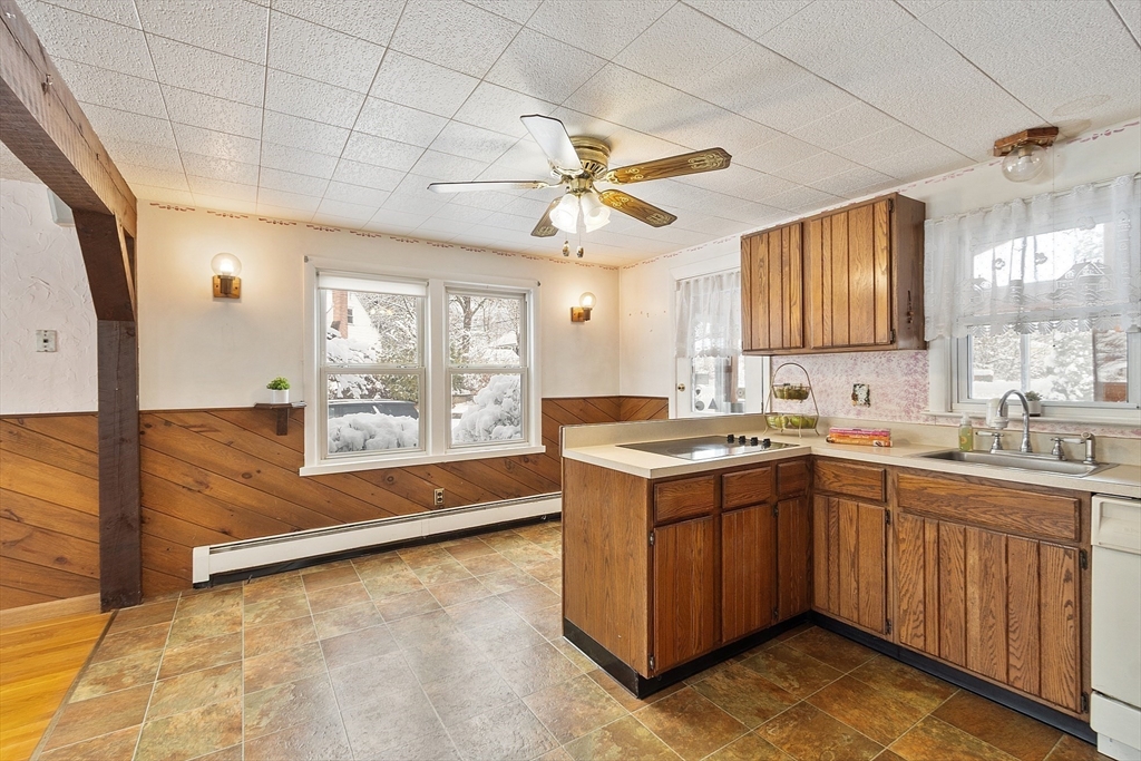10 Pilling Road Wilmington, MA 01887 - Photo 9 of 41 a kitchen with a sink and cabinets