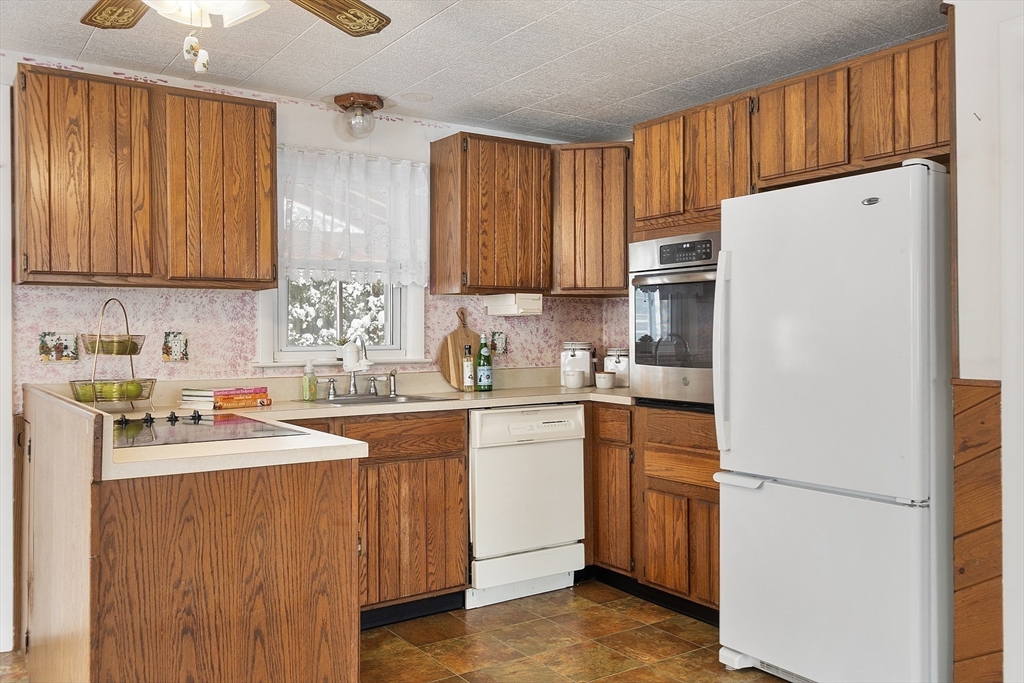 10 Pilling Road Wilmington, MA 01887 - Photo 10 of 41 a kitchen with a white cabinets and white appliances