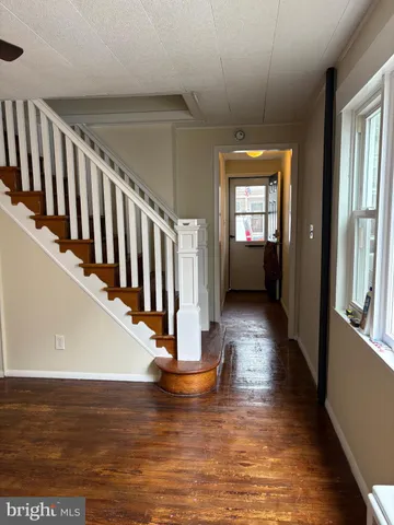 a view of entryway and hall with wooden floor