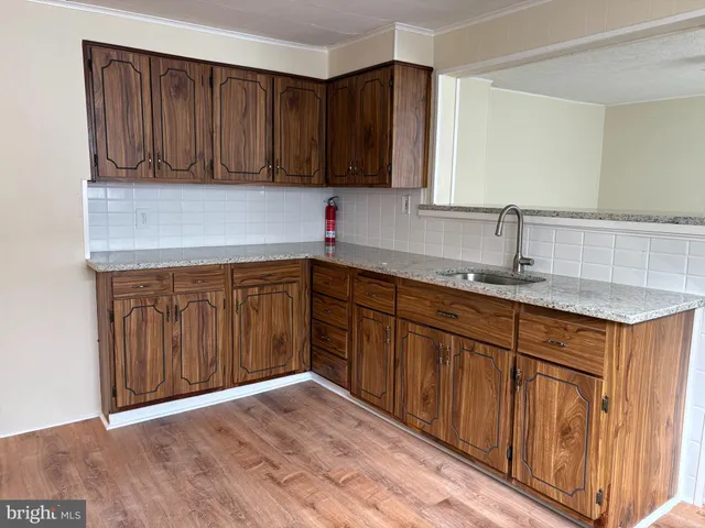 a kitchen with stainless steel appliances granite countertop wooden cabinets a sink and dishwasher