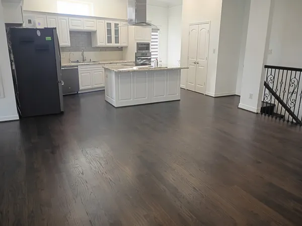 a kitchen with a refrigerator and cabinets