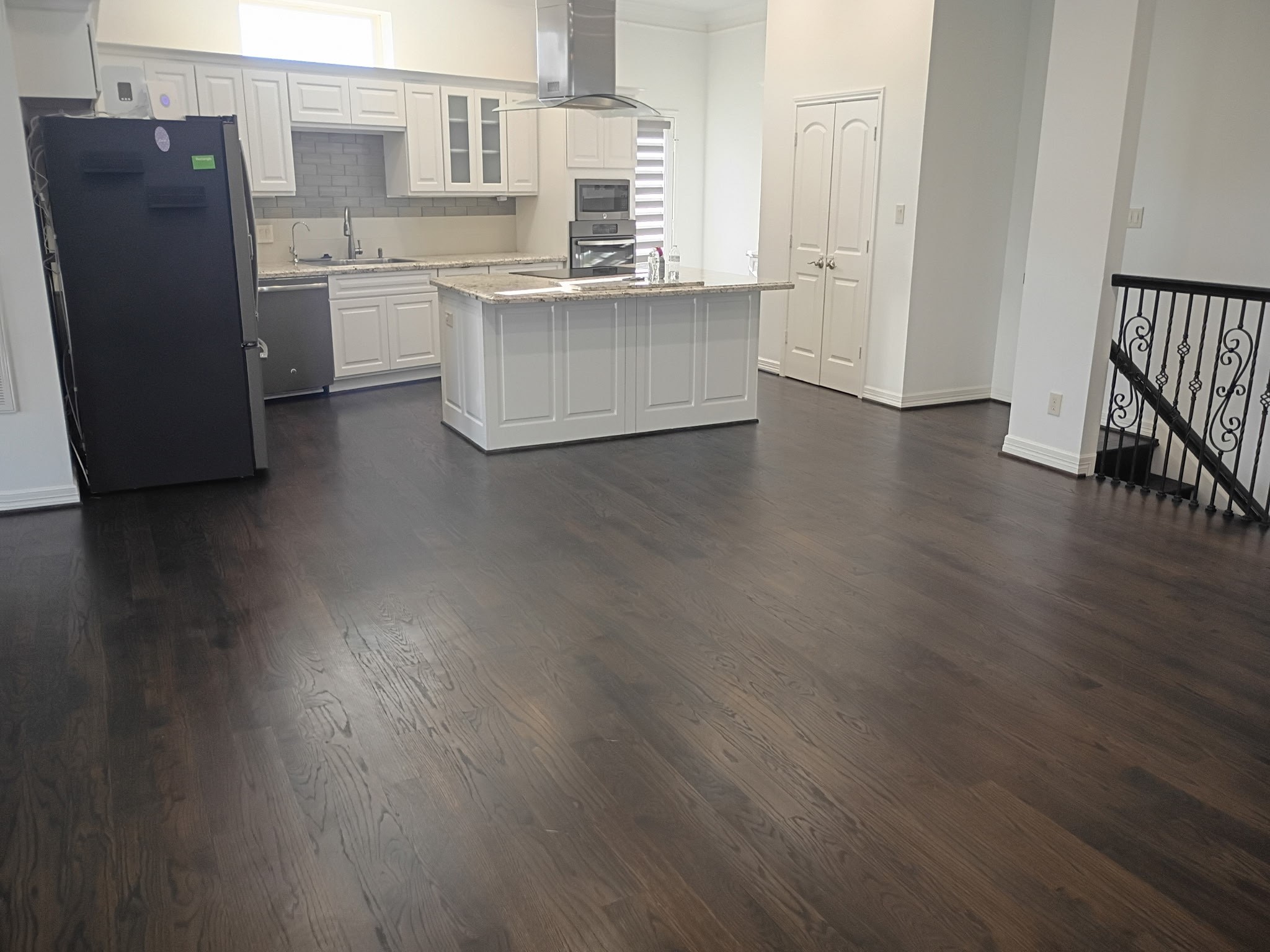 a kitchen with a refrigerator and cabinets