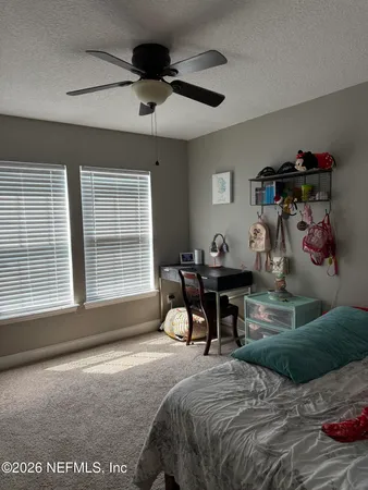 a bedroom with bed and a window