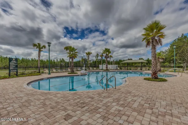 a view of swimming pool with outdoor seating and yard in back