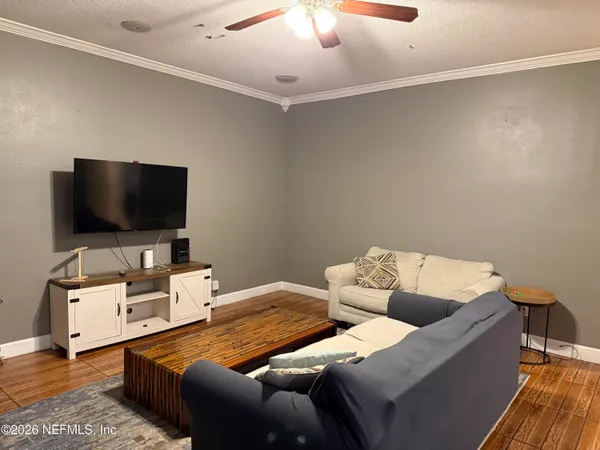 a living room with furniture and a flat screen tv