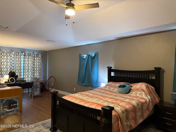 a bed sitting in a bedroom next to a window