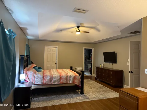 a bedroom with a bed and a flat screen tv