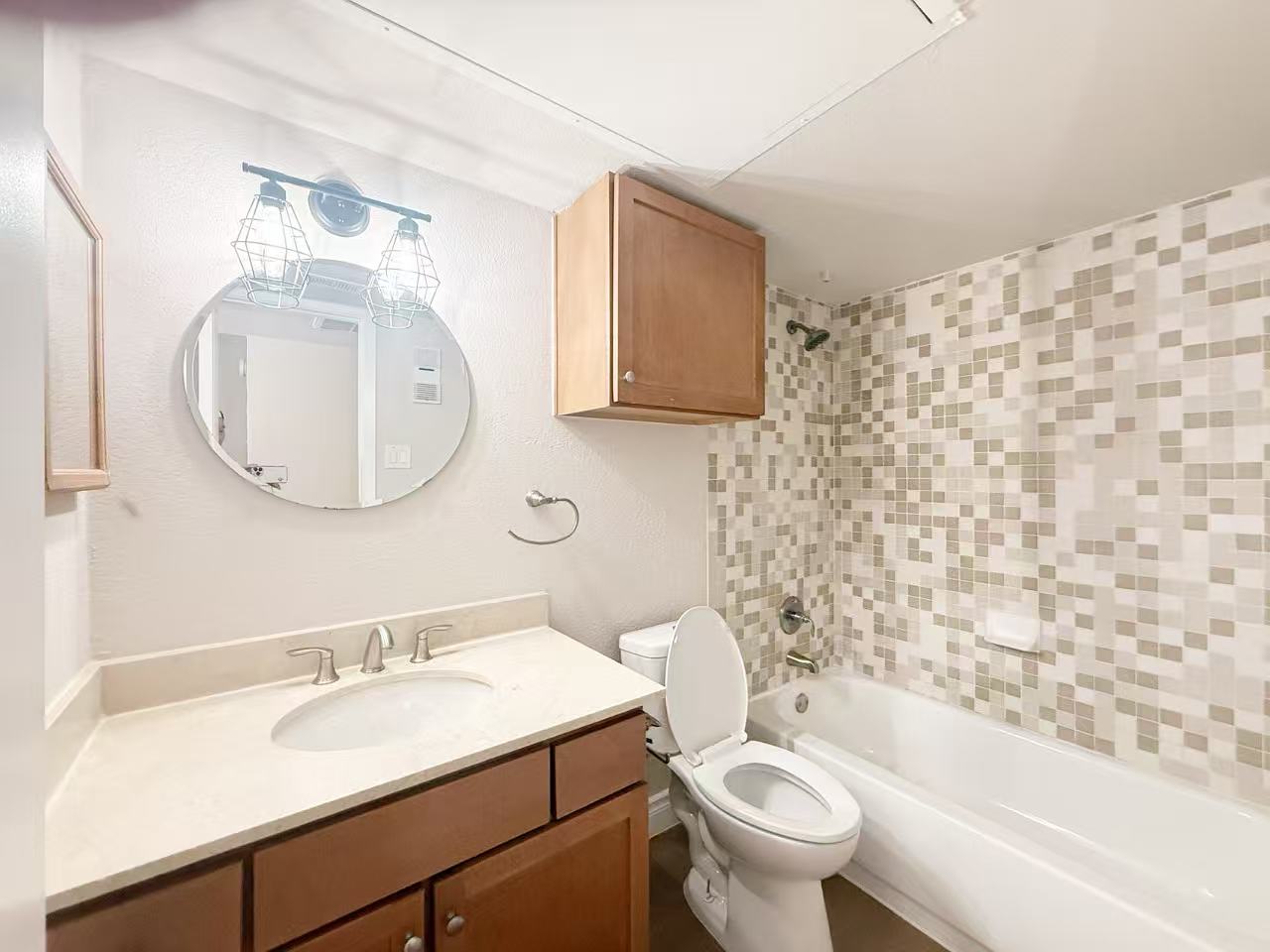 3204 Menchaca Road, Unit 601 Austin, TX 78704 - Photo 7 of 12 a bathroom with a sink toilet and a mirror