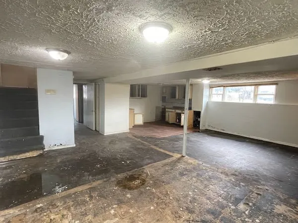 an empty room with a empty space and windows