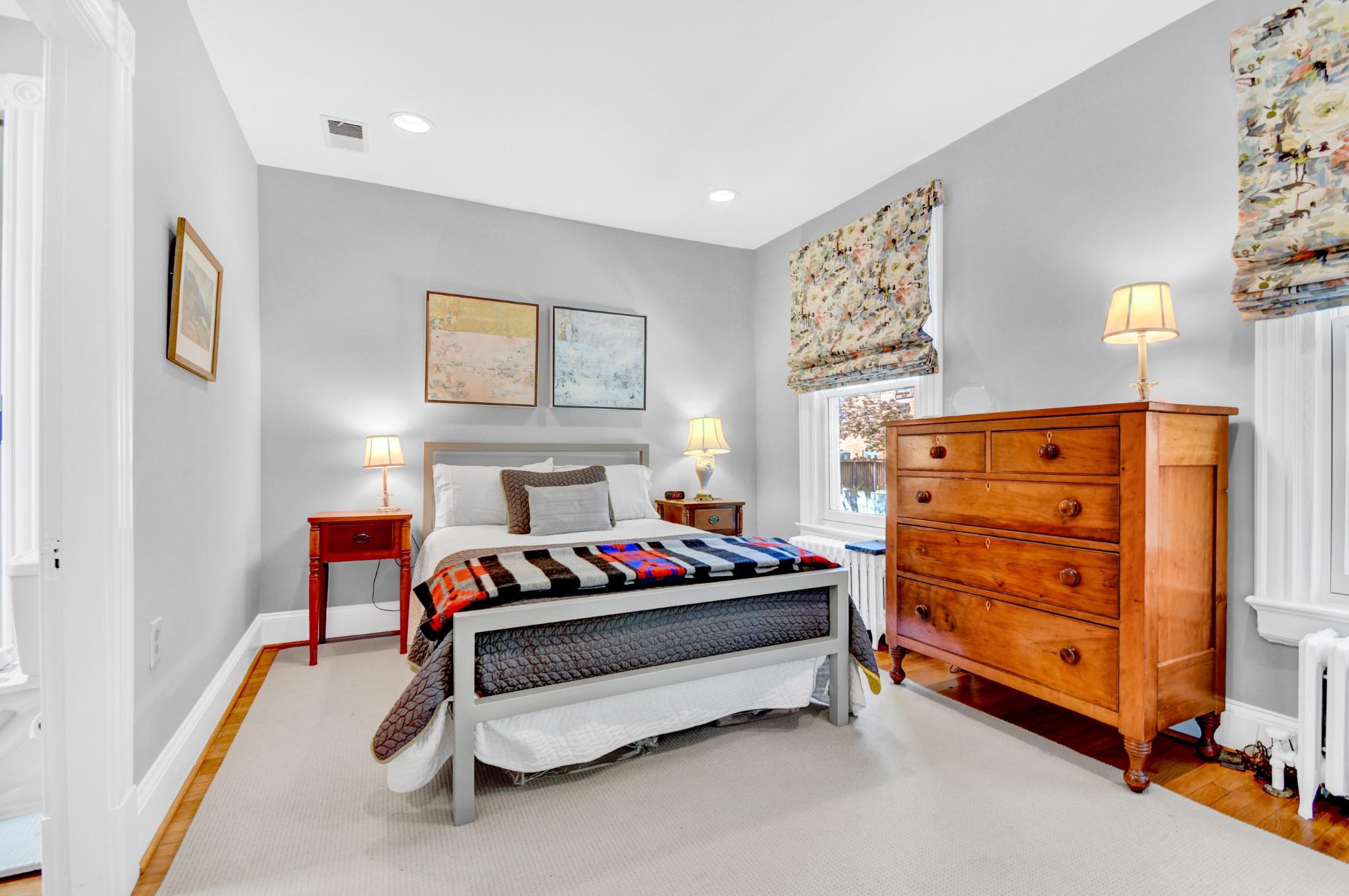 1622 Florida Avenue Northwest Washington, DC 20009 - Photo 19 of 34 a bedroom with bed and paintings on the wall