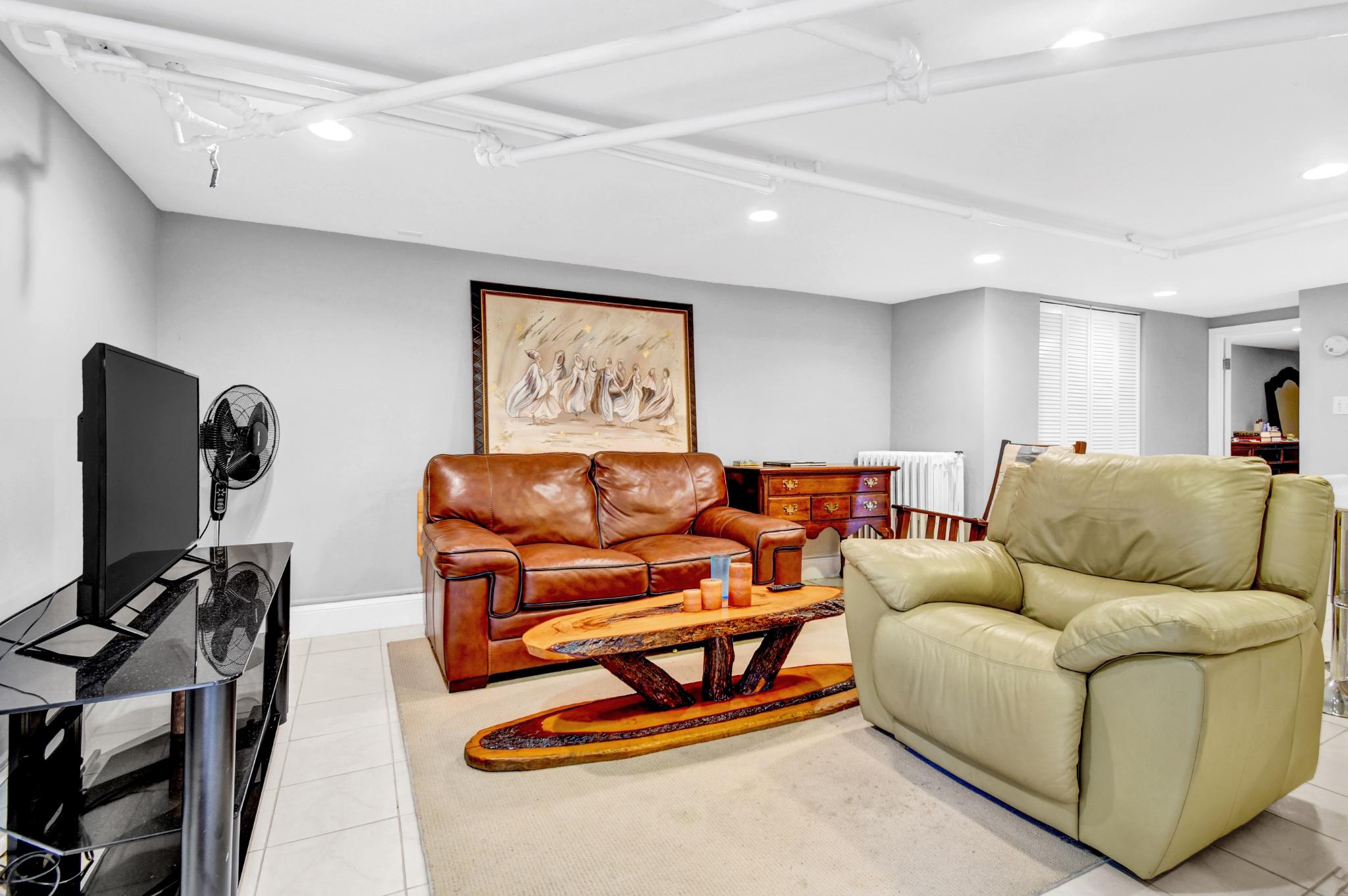 1622 Florida Avenue Northwest Washington, DC 20009 - Photo 27 of 34 a living room with furniture and a flat screen tv