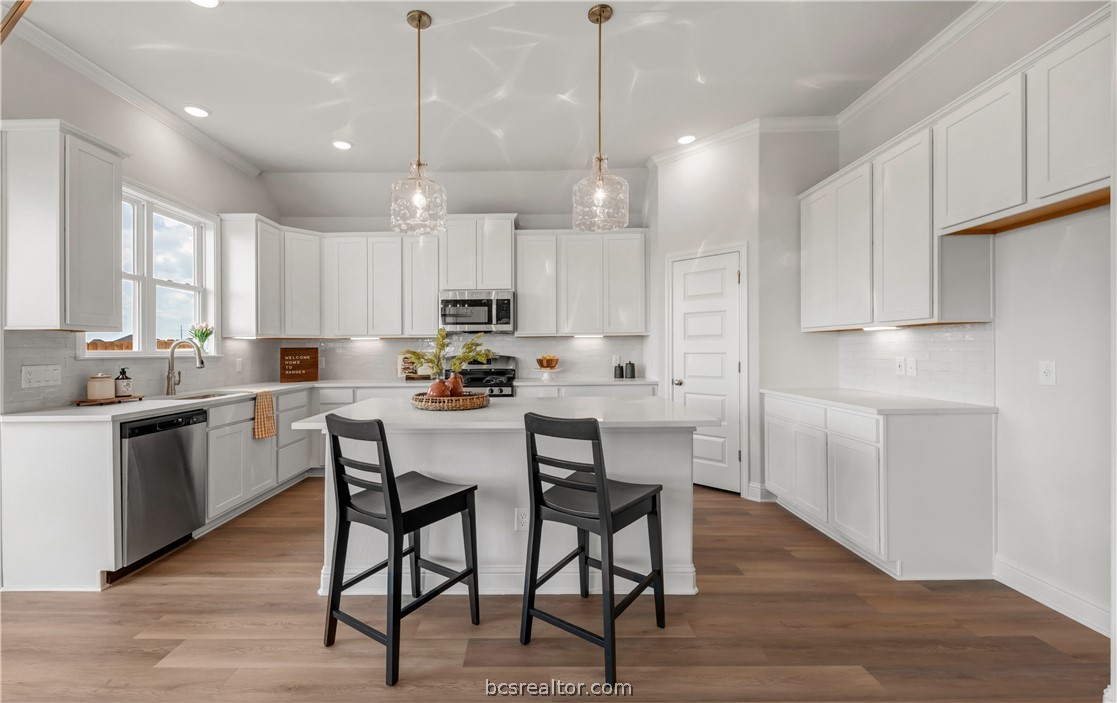a kitchen with kitchen island white cabinets and white appliances