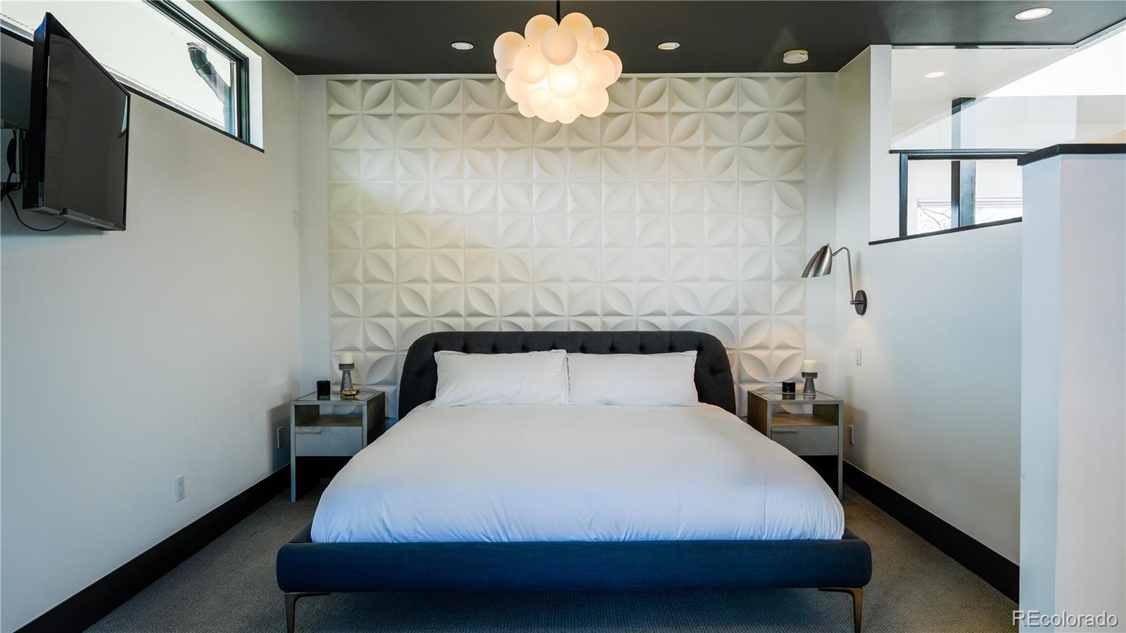 421 Dexter Street Denver, CO 80220 - Photo 15 of 36 a bedroom with a bed and a chandelier