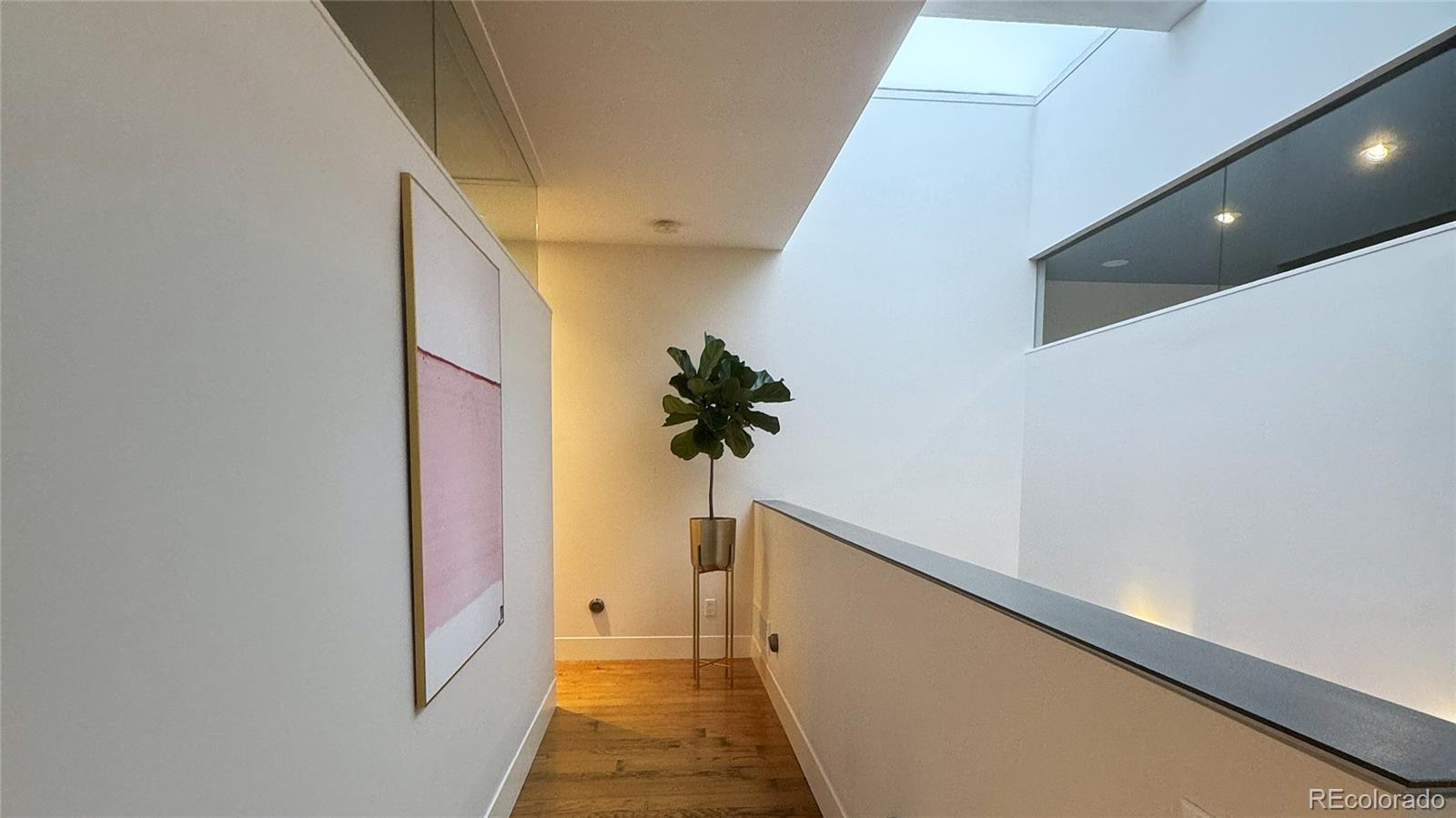421 Dexter Street Denver, CO 80220 - Photo 21 of 36 a view of a hallway with wooden floor and staircase