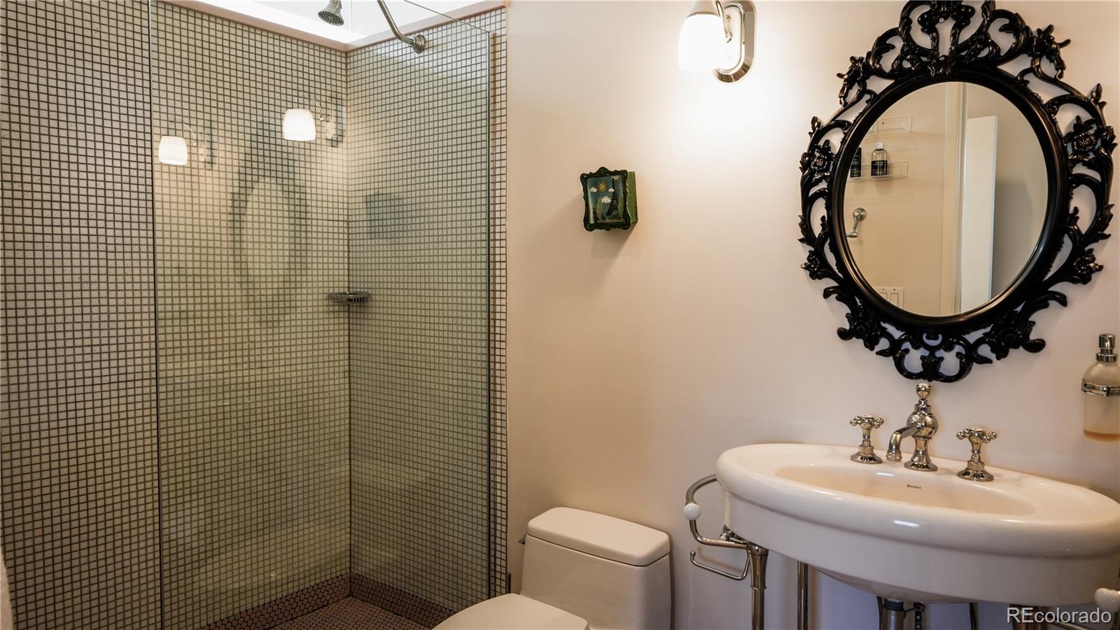421 Dexter Street Denver, CO 80220 - Photo 24 of 36 a bathroom with a sink a toilet and a mirror