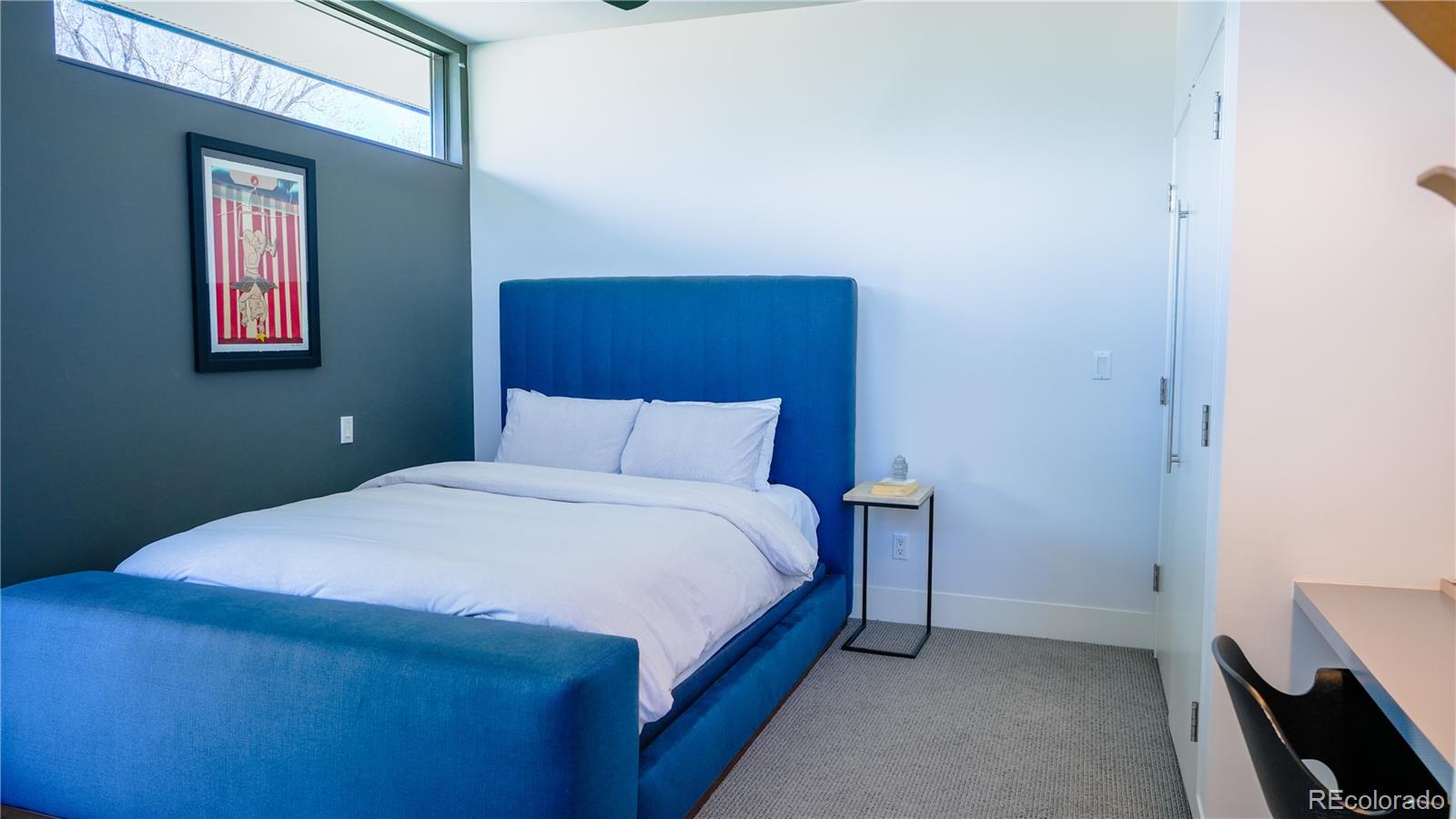 421 Dexter Street Denver, CO 80220 - Photo 27 of 36 a bedroom with a bed and a lamp on dresser