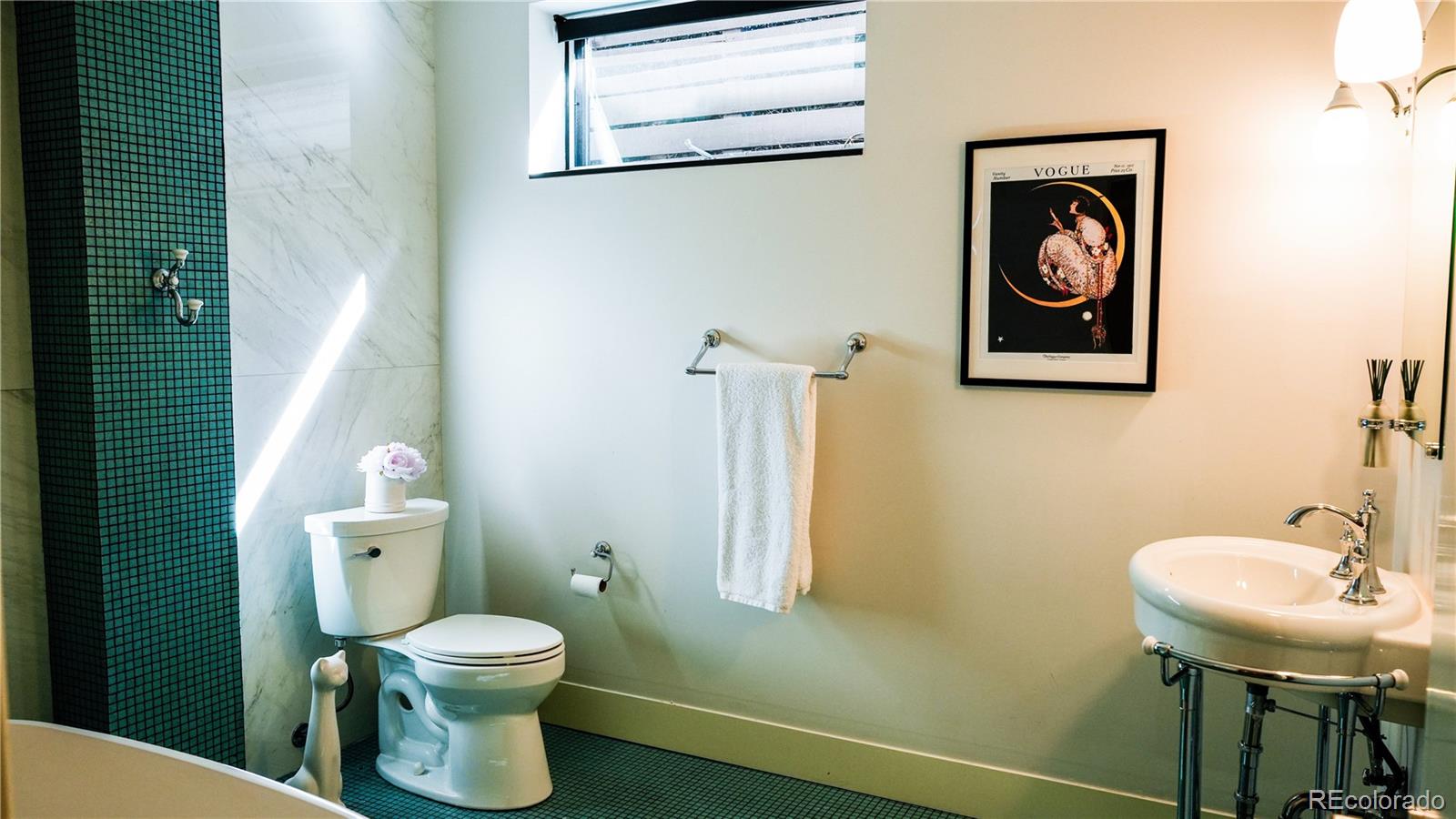 421 Dexter Street Denver, CO 80220 - Photo 34 of 36 a bathroom with a toilet a sink and mirror