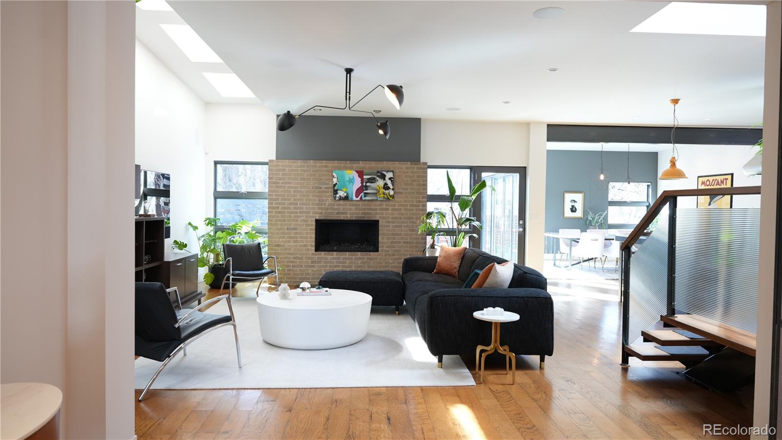 421 Dexter Street Denver, CO 80220 - Photo 5 of 36 a living room with furniture and a fireplace