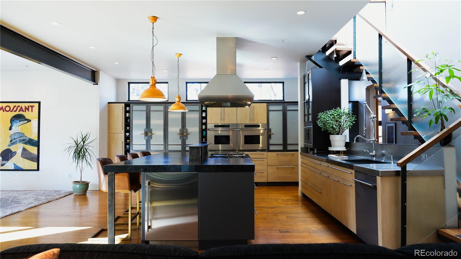 421 Dexter Street Denver, CO 80220 - Photo 6 of 36 a kitchen with stainless steel appliances kitchen island granite countertop a stove and cabinets