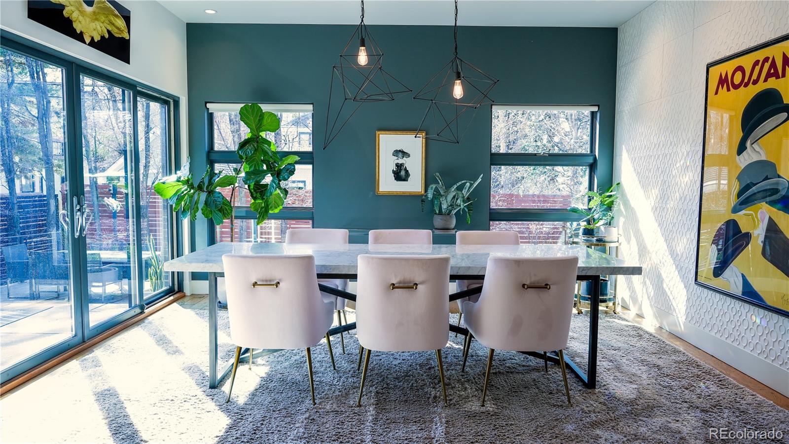 421 Dexter Street Denver, CO 80220 - Photo 9 of 36 a view of a dining room with furniture one side kitchen view and wooden floor