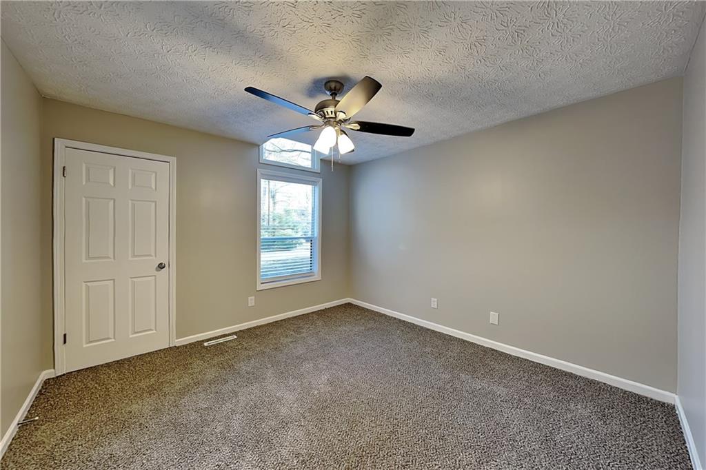 2021 Kramer Way Marietta, GA 30062 - Photo 16 of 21 an empty room with windows and fan