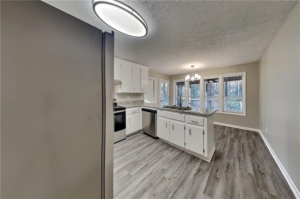 2021 Kramer Way Marietta, GA 30062 - Photo 9 of 21 a kitchen with white cabinets and white appliances