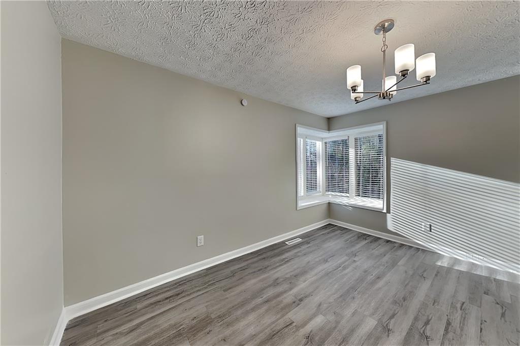2021 Kramer Way Marietta, GA 30062 - Photo 10 of 21 wooden floor in an empty room with a window