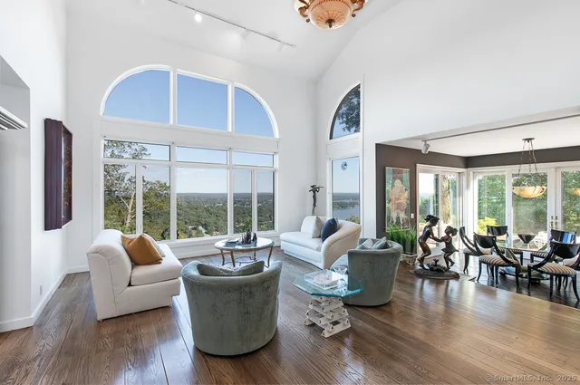 a living room with furniture and floor to ceiling windows