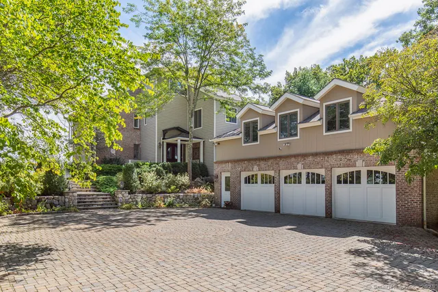 a front view of a house with a yard and a garage