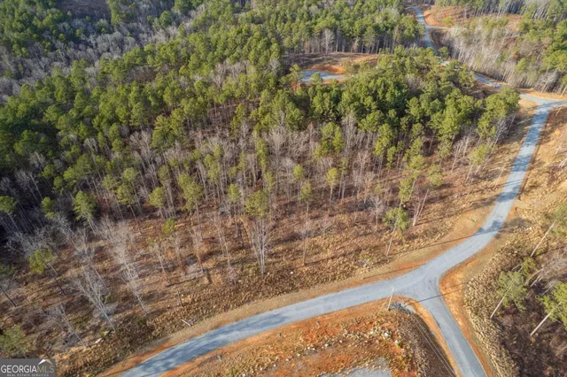 a view of a yard with a wooden wall