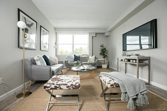 a living room with furniture and wooden floor
