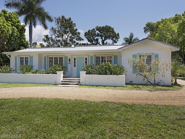 116 3rd Street North Naples, FL 34102 - Photo 1 of 8 front view of house with a yard