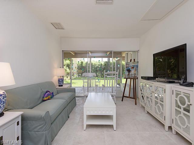 116 3rd Street North Naples, FL 34102 - Photo 2 of 8 a living room with furniture and a flat screen tv
