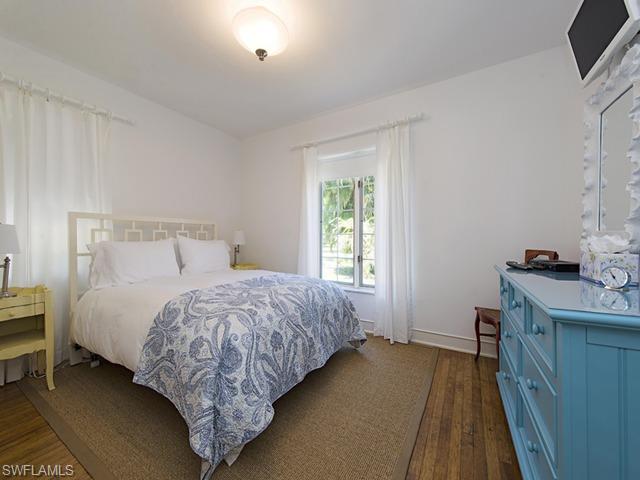 116 3rd Street North Naples, FL 34102 - Photo 7 of 8 a bedroom with a bed and a window