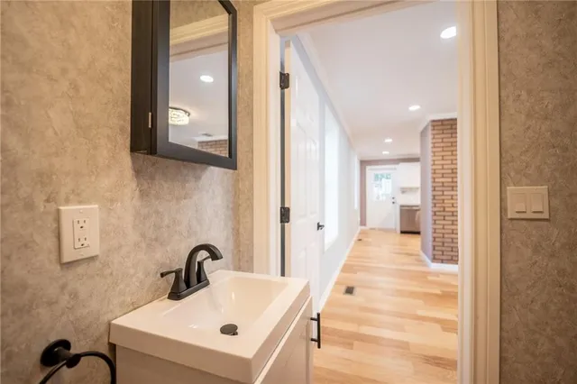 a bathroom with a sink and mirror