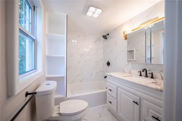 a bathroom with a sink a toilet and a bathtub