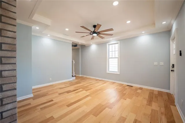 a view of a livingroom with a ceiling fan and window