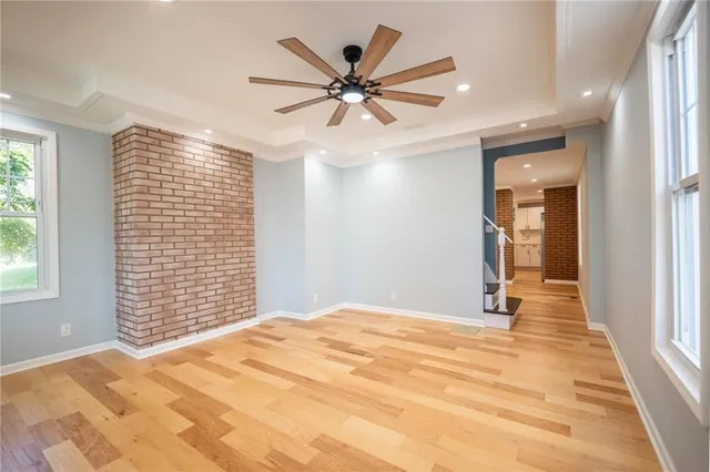 a view of a livingroom with a ceiling fan and window