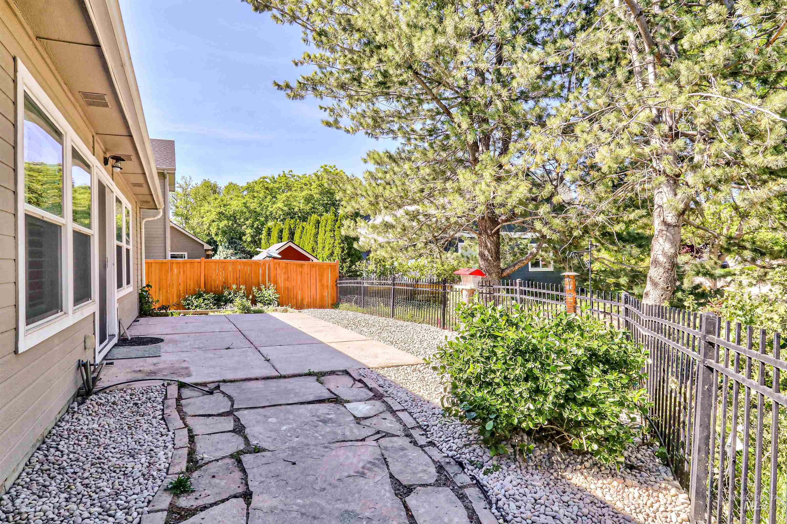892 South Capitola Way Boise, ID 83712 - Photo 31 of 34 Rear exterior featuring a flagstone patio, gravel landscaping, and a privacy fence